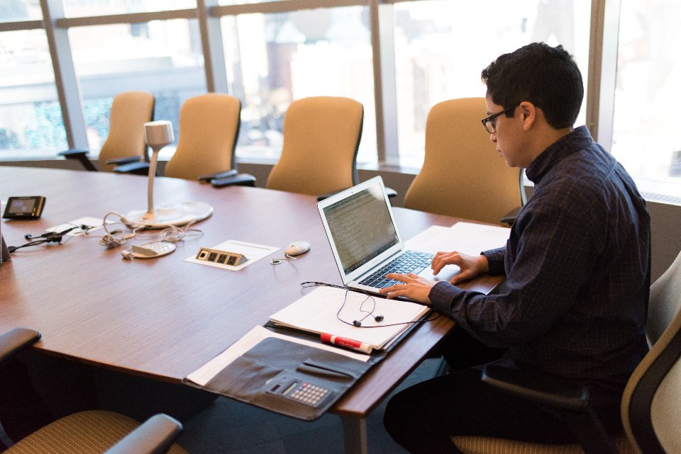 Web developers reviewing a custom software build in a meeting room